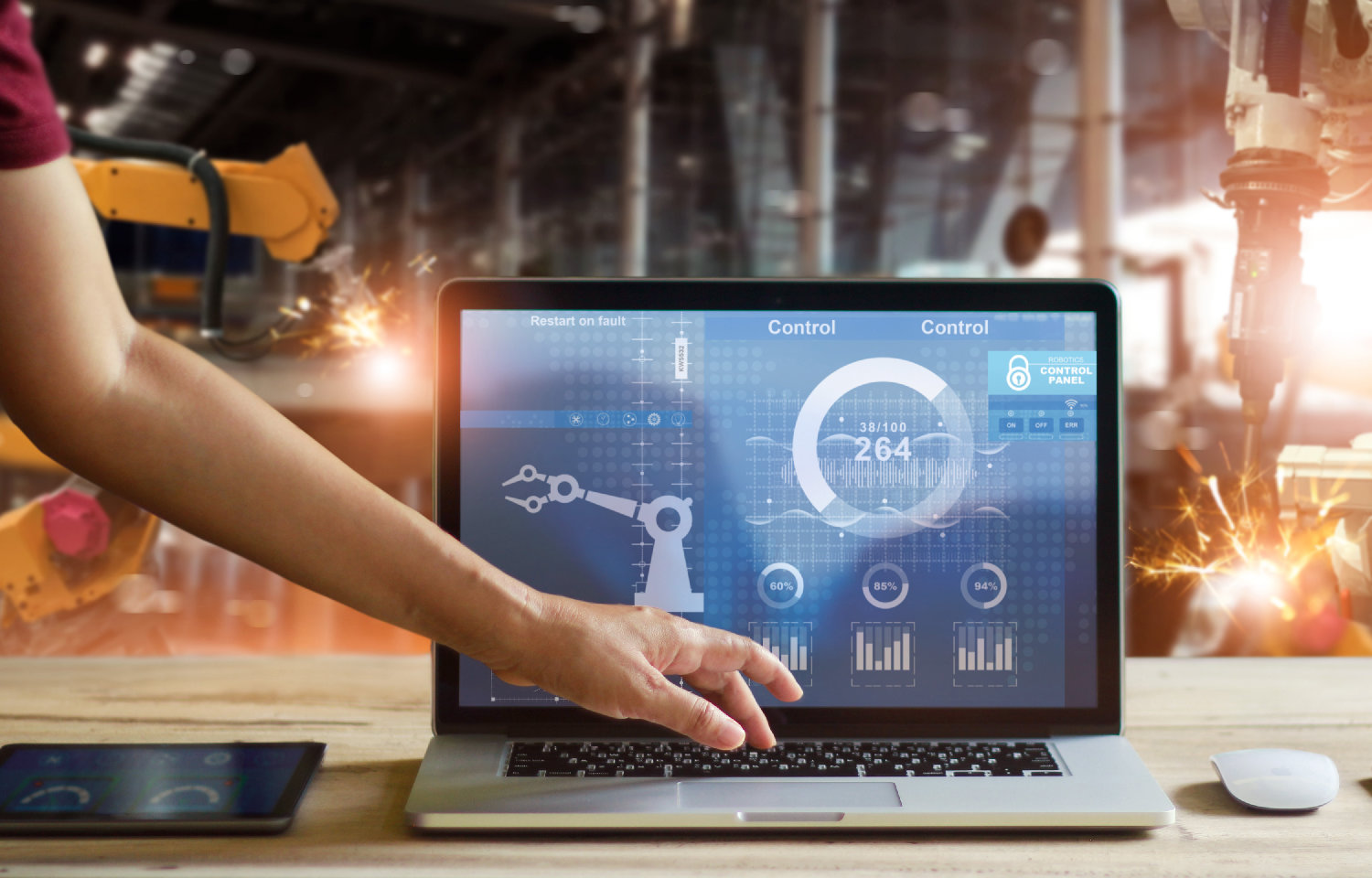 Engineer touching laptop to check and control welding robotics automatic arms machine in intelligent factory automotive industrial with monitoring system software. Digital manufacturing operation.Industry 4.0